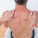 Doctor examining his patient shoulder in medical office